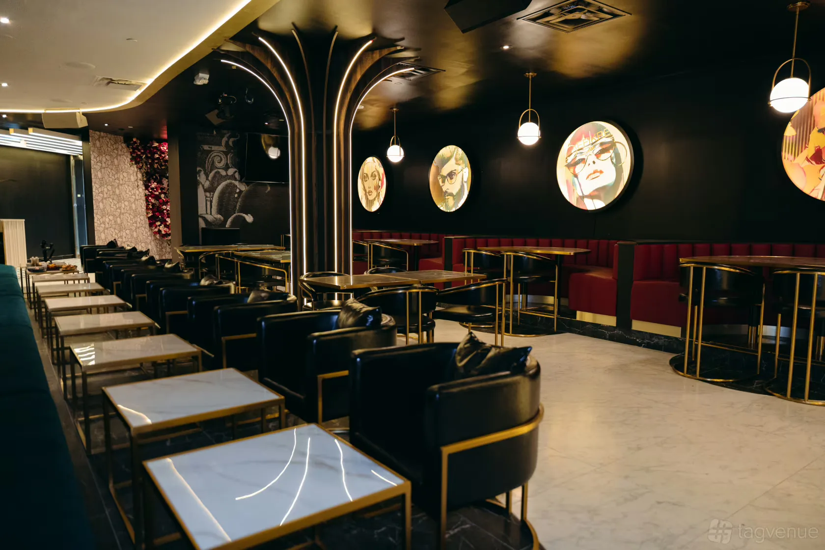 Befikre's dining room with marble tables, gold accents, red banquettes and portrait artwork